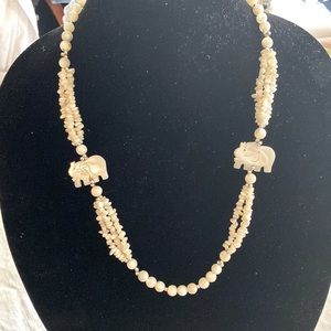 Ivory colored shell and stone necklace.